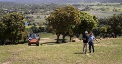 Vue paysage en Corse représentant en premier deux personnes qui discutent à droite et un tracteur à gauche de la photo